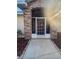 Inviting front entry with brick and screened door at 6844 Northlake Dr, Zephyrhills, FL 33542