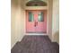 Modern front entry with pink double doors at 6844 Northlake Dr, Zephyrhills, FL 33542