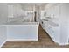 Bright white kitchen with ample counter space and wood-look floors at 6844 Northlake Dr, Zephyrhills, FL 33542