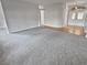 Spacious living room with grey carpet and hardwood floors at 6844 Northlake Dr, Zephyrhills, FL 33542