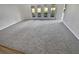 Bright living room featuring a gray carpet and access to the outdoors at 6844 Northlake Dr, Zephyrhills, FL 33542
