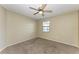 Well-lit bedroom with ceiling fan and carpet flooring at 408 Wedgefield Pl, Brandon, FL 33510