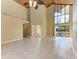 Spacious living area with high ceilings, tile floors, and a view of the backyard at 408 Wedgefield Pl, Brandon, FL 33510