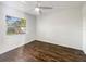 Well-lit bedroom featuring hardwood floors and a large window at 4606 Southbreeze Dr, Tampa, FL 33624