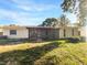 Exterior view of house with screened patio and yard at 4606 Southbreeze Dr, Tampa, FL 33624