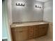 Bathroom featuring double sinks with granite countertops and stylish lighting fixtures at 12263 Cartouche Ave, Punta Gorda, FL 33955