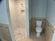 Bathroom features a tiled walk-in shower and toilet with tile accents at 12263 Cartouche Ave, Punta Gorda, FL 33955