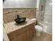 Bathroom with stylish vessel sink, granite counters, and tiled tub with shower at 12263 Cartouche Ave, Punta Gorda, FL 33955