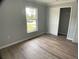 Bedroom with luxury vinyl plank flooring, closet, and natural light from window at 12263 Cartouche Ave, Punta Gorda, FL 33955