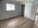 Bedroom with wood-look flooring, closet and window, providing a cozy and functional space at 12263 Cartouche Ave, Punta Gorda, FL 33955
