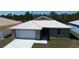 Inviting single-story home with a spacious driveway, two-car garage, and modern metal roof at 12263 Cartouche Ave, Punta Gorda, FL 33955