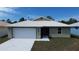 Charming single-story home featuring a two-car garage, well-maintained lawn, and modern metal roof at 12263 Cartouche Ave, Punta Gorda, FL 33955