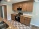 Well-lit kitchen features stainless steel appliances, granite countertops, and geometric patterned flooring at 12263 Cartouche Ave, Punta Gorda, FL 33955