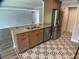Open concept kitchen featuring granite countertops, stainless appliances, and decorative floor tile at 12263 Cartouche Ave, Punta Gorda, FL 33955