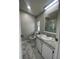 Clean bathroom with updated vanity and a large mirror at 3145 Hidden Lake Dr, Wesley Chapel, FL 33543