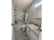 Clean bathroom with marble-look tile and updated vanity at 3145 Hidden Lake Dr, Wesley Chapel, FL 33543