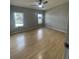 Large bedroom featuring light wood laminate flooring and a ceiling fan at 3145 Hidden Lake Dr, Wesley Chapel, FL 33543