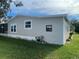 Side view of a tan mobile home with landscaping at 3145 Hidden Lake Dr, Wesley Chapel, FL 33543