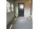 Enclosed sunroom with concrete floor and exterior door at 3145 Hidden Lake Dr, Wesley Chapel, FL 33543