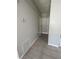 Simple hallway with light gray walls and tile flooring at 3145 Hidden Lake Dr, Wesley Chapel, FL 33543
