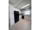 Modern kitchen with white cabinets and black appliances at 3145 Hidden Lake Dr, Wesley Chapel, FL 33543