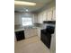 Updated kitchen with granite counters and black appliances at 3145 Hidden Lake Dr, Wesley Chapel, FL 33543