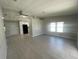 Open living room with tile floors and kitchen view at 3145 Hidden Lake Dr, Wesley Chapel, FL 33543