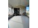Screened patio with wicker chairs and access to home at 3145 Hidden Lake Dr, Wesley Chapel, FL 33543