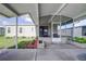 Covered screened porch with paver patio and landscaped area at 3145 Hidden Lake Dr, Wesley Chapel, FL 33543