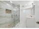 Modern bathroom features glass shower door, marble tile, mosaic tile accent, and single vanity at 4367 Albacore Cir, Port Charlotte, FL 33948
