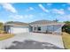 This home features a wide driveway, a two-car garage, and well-maintained landscaping at 4367 Albacore Cir, Port Charlotte, FL 33948