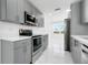 Close up of modern gray kitchen featuring stainless appliances, white countertops, and marble floors at 4367 Albacore Cir, Port Charlotte, FL 33948