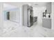 Updated kitchen with stainless appliances, gray cabinets, and marble floors flows into the living area at 4367 Albacore Cir, Port Charlotte, FL 33948