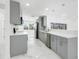 Updated kitchen features grey cabinets, quartz counters, and stainless appliances with lots of natural light at 4367 Albacore Cir, Port Charlotte, FL 33948