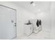 This bright laundry room features modern washer and dryer, utility sink, and a door to the exterior at 4367 Albacore Cir, Port Charlotte, FL 33948