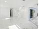 Spacious living room with marble floors, white walls, and access to the screened patio through sliding glass doors at 4367 Albacore Cir, Port Charlotte, FL 33948