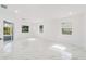 Bright living room featuring marble floors, white walls, and several windows offering lots of natural light at 4367 Albacore Cir, Port Charlotte, FL 33948