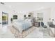 Staged main bedroom with marble floors, neutral walls, and a screened lanai offers indoor outdoor living at 4367 Albacore Cir, Port Charlotte, FL 33948