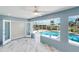 The sliding door opens from the patio to the sunroom and offers views of the screened-in pool area at 4367 Albacore Cir, Port Charlotte, FL 33948