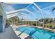 The screened-in pool area features a large pool and outdoor seating area surrounded by lush landscaping at 4367 Albacore Cir, Port Charlotte, FL 33948