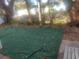 Backyard with artificial turf and mature trees at 2695 S East Ave, Sarasota, FL 34239