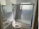 Bathroom with gray tiled shower/tub combo, vanity sink, and toilet at 2695 S East Ave, Sarasota, FL 34239