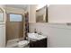 Clean bathroom with shower/tub combo, vanity, and a framed mirror at 2695 S East Ave, Sarasota, FL 34239