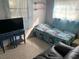 Second bedroom with twin bed, TV, and seating area at 2695 S East Ave, Sarasota, FL 34239