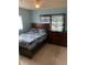 Bedroom with wooden bedframe, dresser, and themed decor at 2695 S East Ave, Sarasota, FL 34239