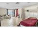 Multipurpose room with a bed, seating area, and sliding door access at 2695 S East Ave, Sarasota, FL 34239