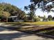 Quaint home with white picket fence, lush landscaping, and convenient driveway parking at 2695 S East Ave, Sarasota, FL 34239