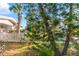 Landscaped yard with trees and white fence at 2695 S East Ave, Sarasota, FL 34239