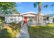Front view of a house with a red door and white picket fence at 2695 S East Ave, Sarasota, FL 34239