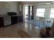 Kitchen and dining area with sliding glass doors opening to a bright Florida room/patio space at 2695 S East Ave, Sarasota, FL 34239